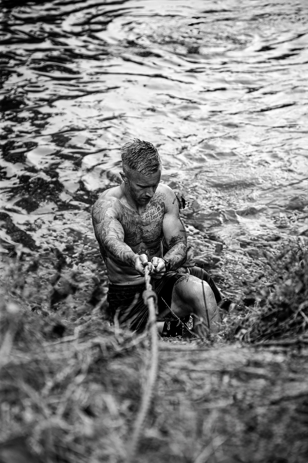 Darren climbing out of the water using a rope