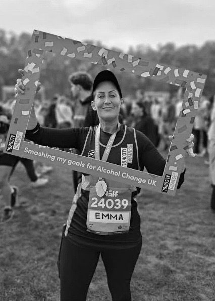 Client wearing a race medal & holding an Alcohol Change UK event frame.
